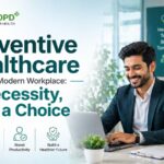 A professional working on a laptop in a modern office, highlighting the importance of preventive healthcare in the workplace to improve employee health and productivity